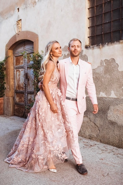 summer wedding dress code: custom blush pinks suit and dress